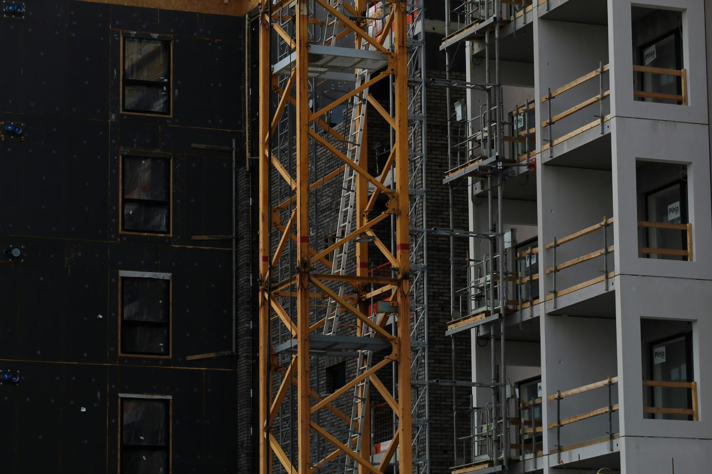 Cast-in-place concrete frame under construction, crane above